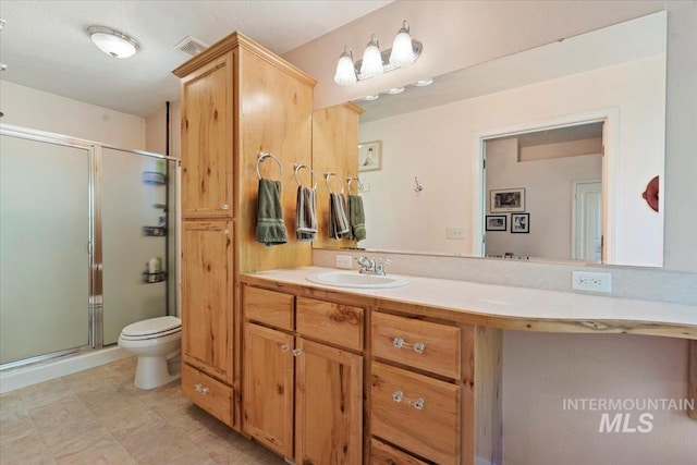 104 Sky Ridge Dr, Garden Valley, ID 83622 - bathroom featuring a stall shower, vanity, and toilet