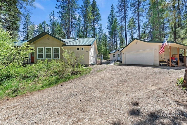 104 Sky Ridge Dr, Garden Valley, ID 83622 - view of side of home featuring driveway, a garage, and metal roof