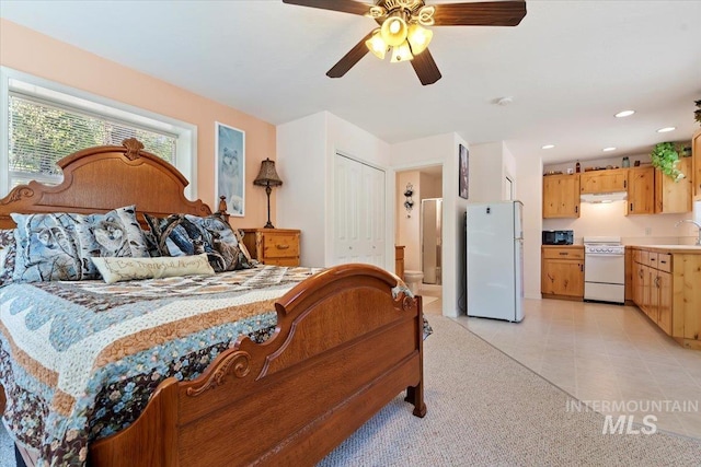 104 Sky Ridge Dr, Garden Valley, ID 83622 - bedroom featuring freestanding refrigerator, ensuite bath, light tile patterned flooring, recessed lighting, and a ceiling fan