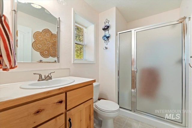 104 Sky Ridge Dr, Garden Valley, ID 83622 - full bathroom with a shower stall, toilet, vanity, and tile patterned flooring