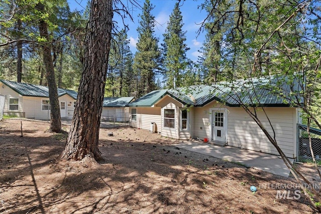 104 Sky Ridge Dr, Garden Valley, ID 83622 - rear view of property featuring metal roof, fence, and a patio