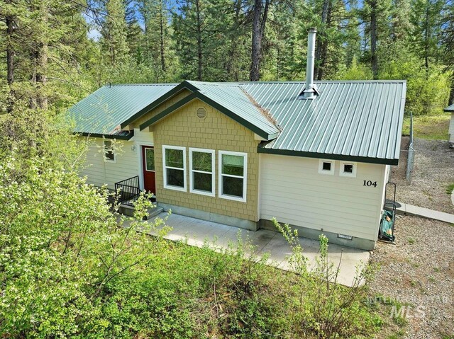 104 Sky Ridge Dr, Garden Valley, ID 83622 - back of house with metal roof and a patio
