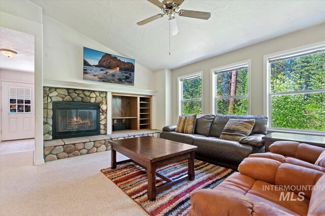 104 Sky Ridge Dr, Garden Valley, ID 83622 - carpeted living area featuring a textured ceiling, lofted ceiling, ceiling fan, and a fireplace