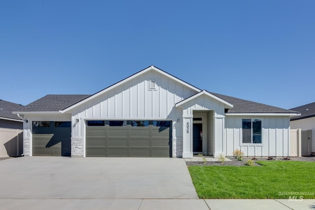 modern farmhouse style home with a garage and a front lawn