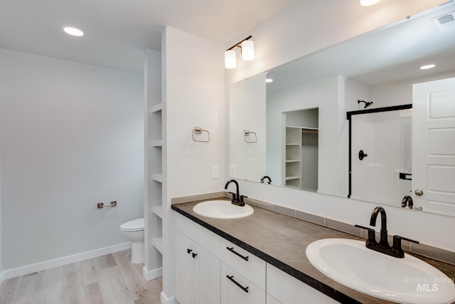 7417 E Shields Dr, Nampa, ID 83687 - full bath with a sink, toilet, wood finished floors, and a shower stall