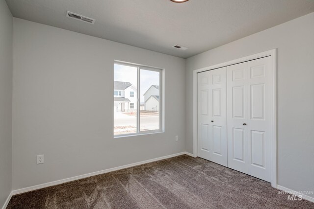 7417 E Shields Dr, Nampa, ID 83687 - unfurnished bedroom featuring baseboards, visible vents, and carpet floors