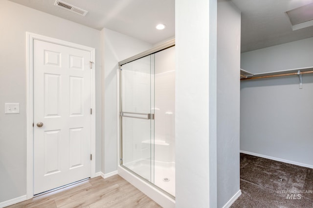 7417 E Shields Dr, Nampa, ID 83687 - bathroom featuring visible vents, wood finished floors, a shower stall, baseboards, and a spacious closet