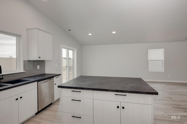 7417 E Shields Dr, Nampa, ID 83687 - kitchen featuring dark countertops, light wood finished floors, backsplash, lofted ceiling, and stainless steel dishwasher