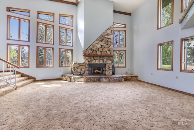 569 Spring Creek Rd, Burley, ID 83318 - unfurnished living room with a towering ceiling, carpet flooring, healthy amount of natural light, and a fireplace