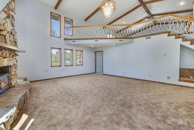569 Spring Creek Rd, Burley, ID 83318 - unfurnished living room featuring a stone fireplace, carpet floors, beamed ceiling, ceiling fan, and stairs