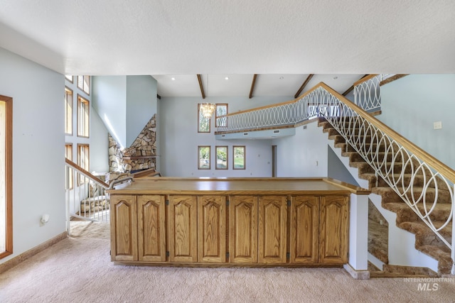 569 Spring Creek Rd, Burley, ID 83318 - stairway with carpet, beam ceiling, baseboards, and a fireplace
