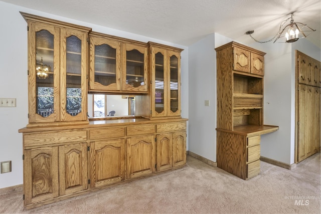 569 Spring Creek Rd, Burley, ID 83318 - bar with light colored carpet, a chandelier, and baseboards