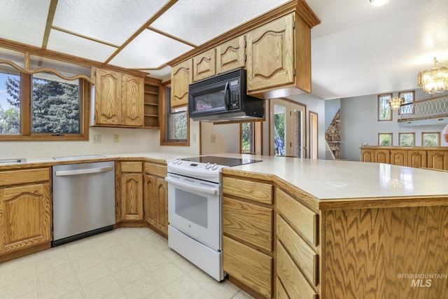 569 Spring Creek Rd, Burley, ID 83318 - kitchen featuring dishwasher, white electric stove, black microwave, a peninsula, and light countertops
