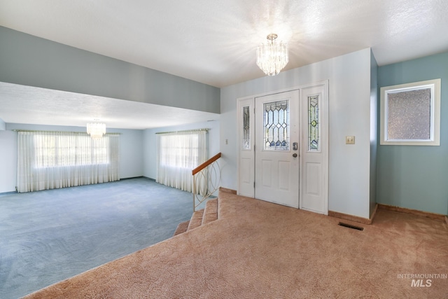 569 Spring Creek Rd, Burley, ID 83318 - entryway with a chandelier, carpet floors, and baseboards