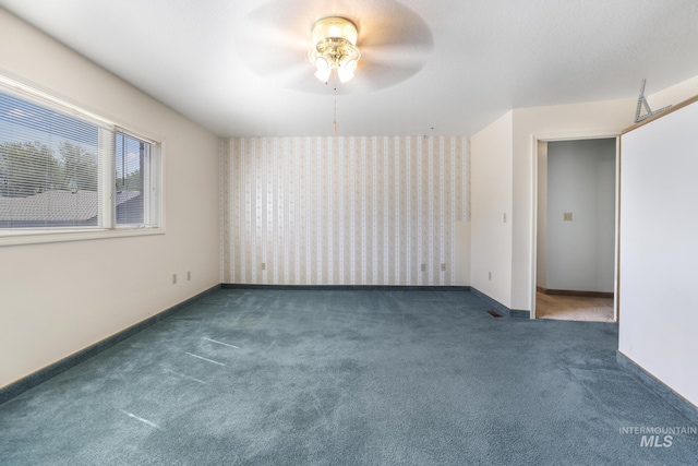 569 Spring Creek Rd, Burley, ID 83318 - carpeted spare room with a ceiling fan, baseboards, and wallpapered walls