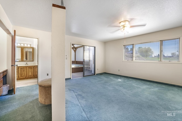 569 Spring Creek Rd, Burley, ID 83318 - unfurnished bedroom with carpet, a textured ceiling, baseboards, ensuite bath, and a ceiling fan