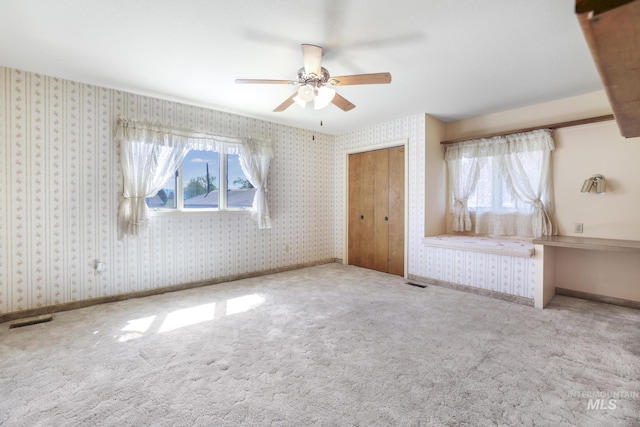 569 Spring Creek Rd, Burley, ID 83318 - unfurnished bedroom with multiple windows, carpet floors, wallpapered walls, and ceiling fan