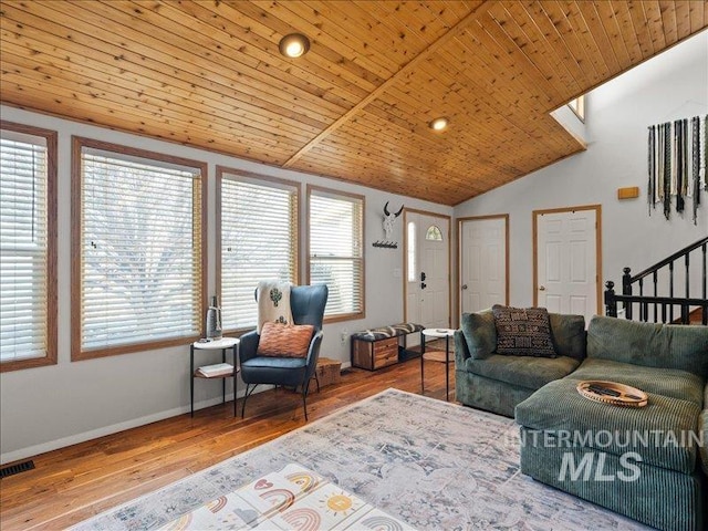 living room featuring lofted ceiling, hardwood / wood-style floors, and wooden ceiling