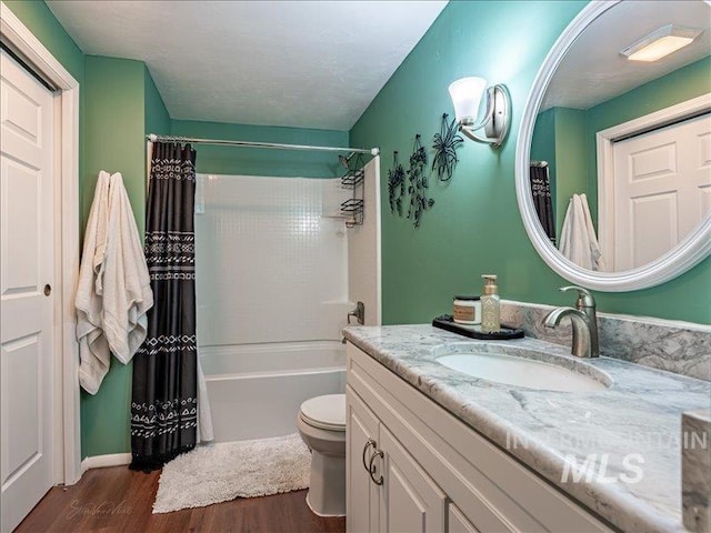 full bathroom featuring vanity, toilet, shower / tub combo, and hardwood / wood-style floors