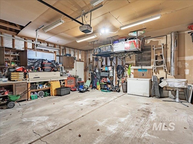 garage featuring a garage door opener and a workshop area