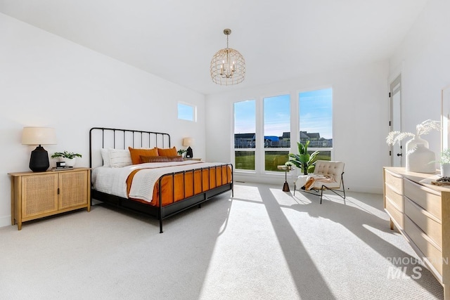 bedroom featuring light carpet, baseboards, and an inviting chandelier