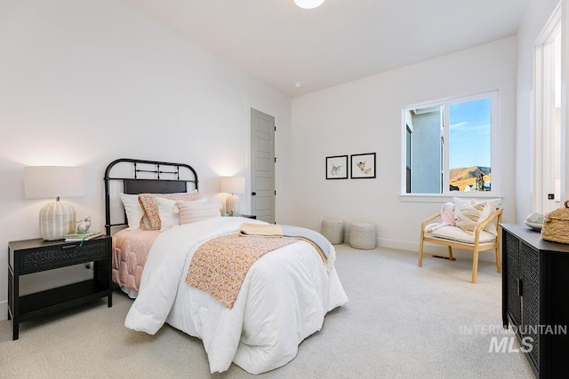 bedroom with carpet floors, multiple windows, and baseboards