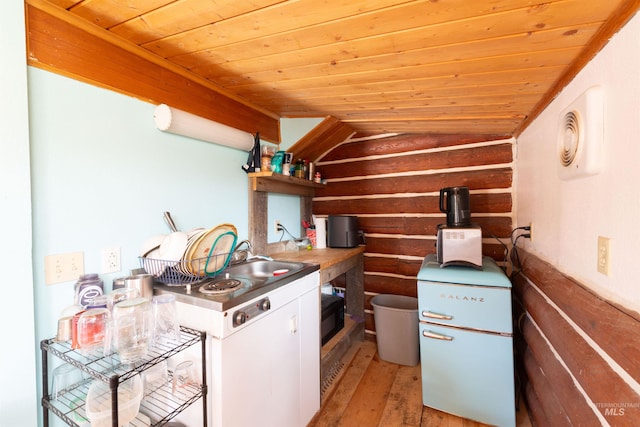 130 Valley Creek Rd, Stanley, ID 83278 - kitchen with log walls, wooden ceiling, light wood-style flooring, vaulted ceiling, and open shelves