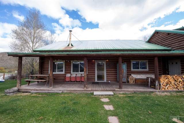 130 Valley Creek Rd, Stanley, ID 83278 - rear view of property featuring a lawn, metal roof, log exterior, and a deck