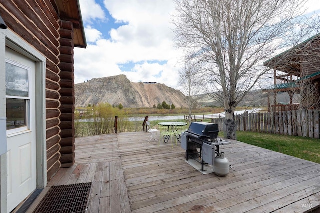 130 Valley Creek Rd, Stanley, ID 83278 - wooden deck featuring grilling area, a water and mountain view, and outdoor dining area