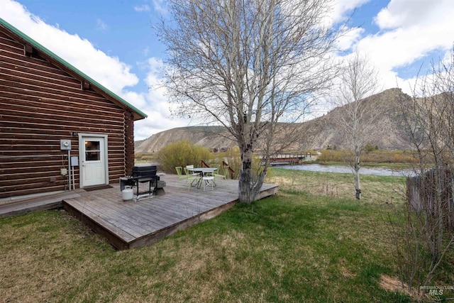 130 Valley Creek Rd, Stanley, ID 83278 - view of green lawn with a deck with water view
