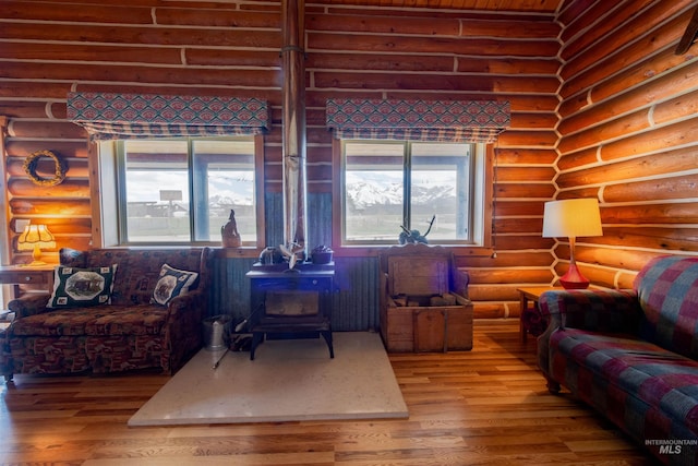 130 Valley Creek Rd, Stanley, ID 83278 - living area with a wood stove, log walls, and wood finished floors