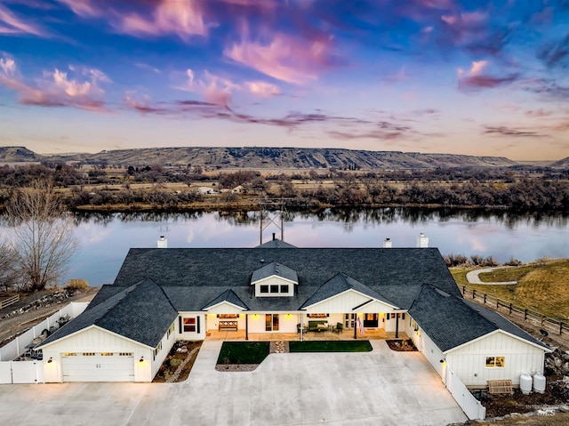 aerial view at dusk with a water view