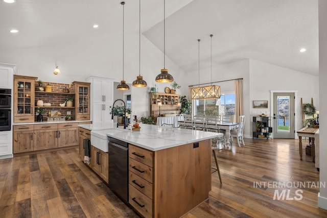 kitchen featuring decorative light fixtures, a sink, dishwasher, and open shelves