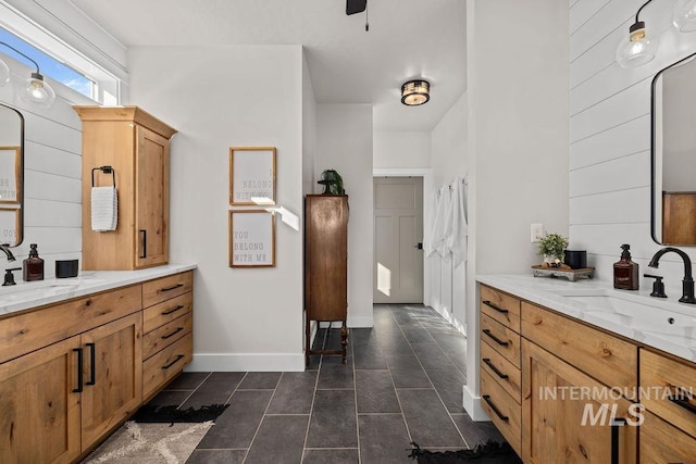 bathroom with tile patterned flooring, two vanities, and a sink