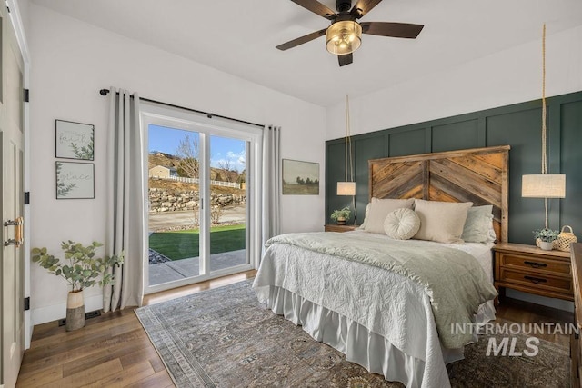 bedroom featuring access to outside, ceiling fan, and wood finished floors