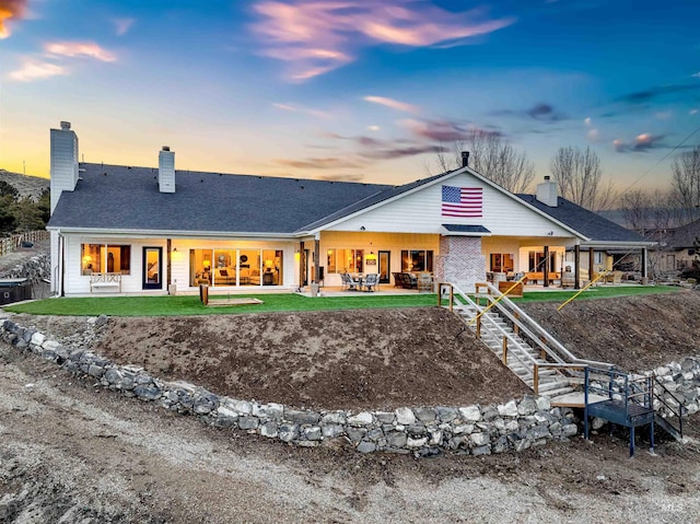 rear view of house with a patio and a chimney