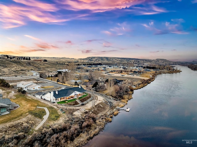 drone / aerial view with a water and mountain view