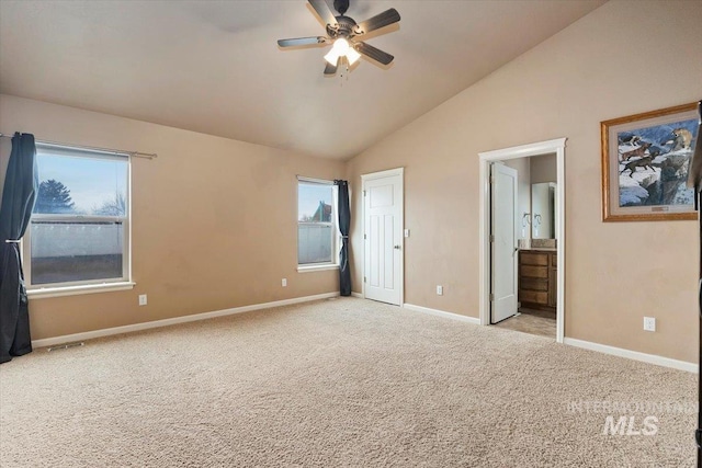 unfurnished bedroom featuring visible vents, ensuite bath, carpet flooring, baseboards, and vaulted ceiling