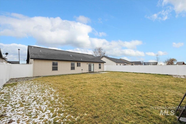 back of property featuring a lawn and a fenced backyard