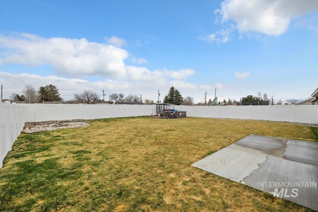 view of yard featuring a patio area and a fenced backyard