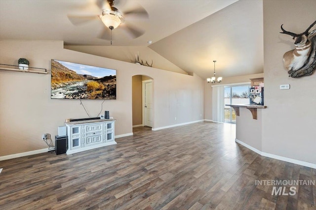 unfurnished living room with lofted ceiling, ceiling fan with notable chandelier, wood finished floors, arched walkways, and baseboards