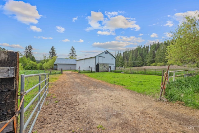 478AND716 Three Bear Rd, Kendrick, ID 83537 - view of yard featuring a barn, a view of countryside, an outbuilding, and a view of trees