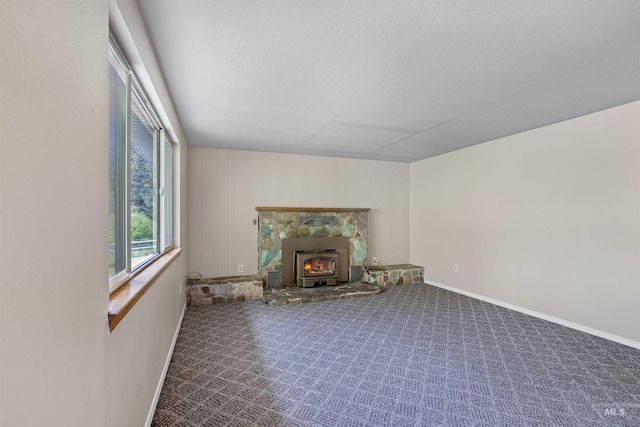 478AND716 Three Bear Rd, Kendrick, ID 83537 - unfurnished living room featuring baseboards, carpet, and a wood stove