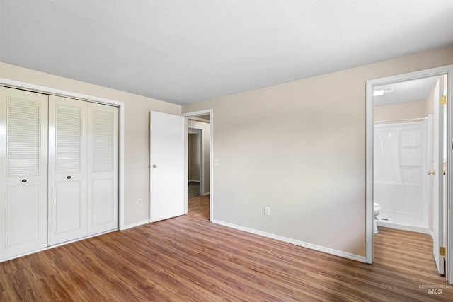 478AND716 Three Bear Rd, Kendrick, ID 83537 - unfurnished bedroom with wood finished floors, baseboards, a closet, and connected bathroom