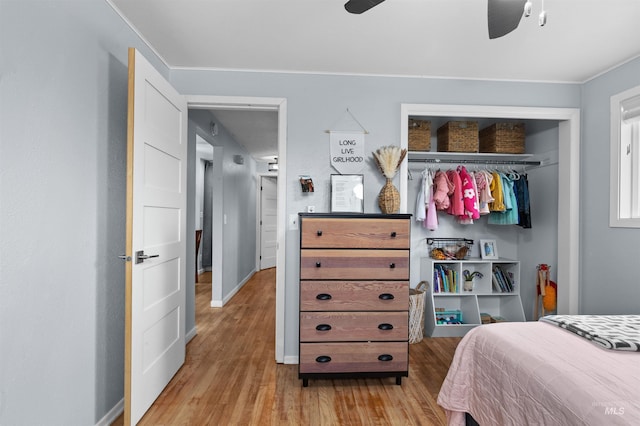 bedroom featuring light hardwood / wood-style flooring, a closet, and ceiling fan