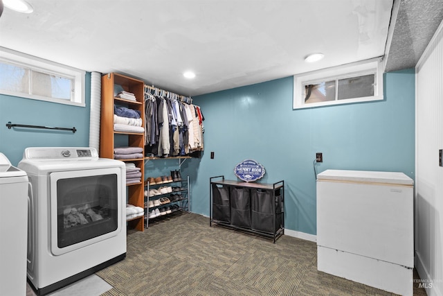 laundry area with separate washer and dryer and dark carpet