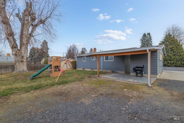 back of property with a playground and a patio