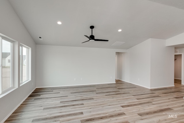 spare room with lofted ceiling, light hardwood / wood-style flooring, and ceiling fan