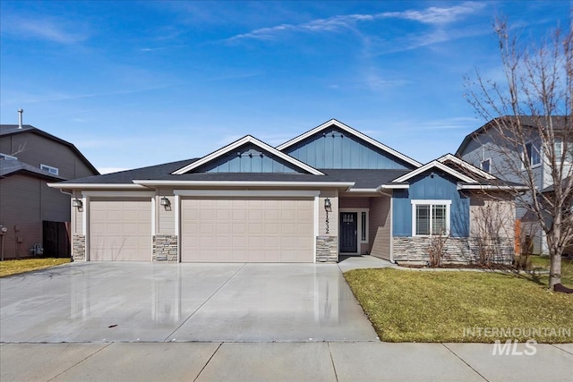 craftsman house with a garage, driveway, stone siding, a front lawn, and board and batten siding