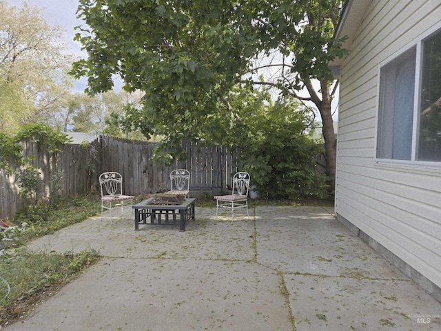 view of patio with an outdoor fire pit and fence private yard